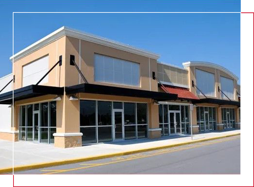 A large commercial building with many windows on the street.