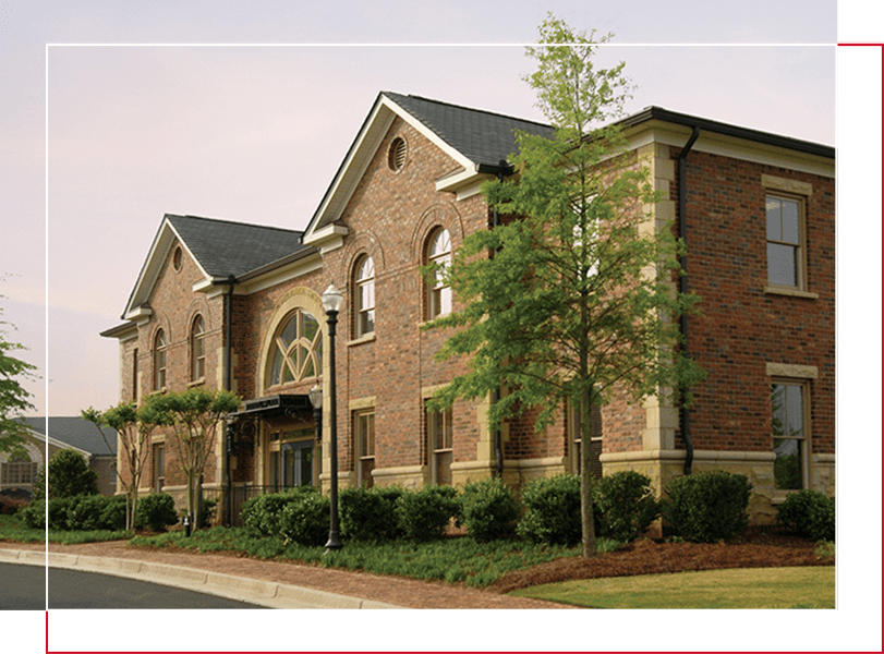 A brick building with trees in front of it.