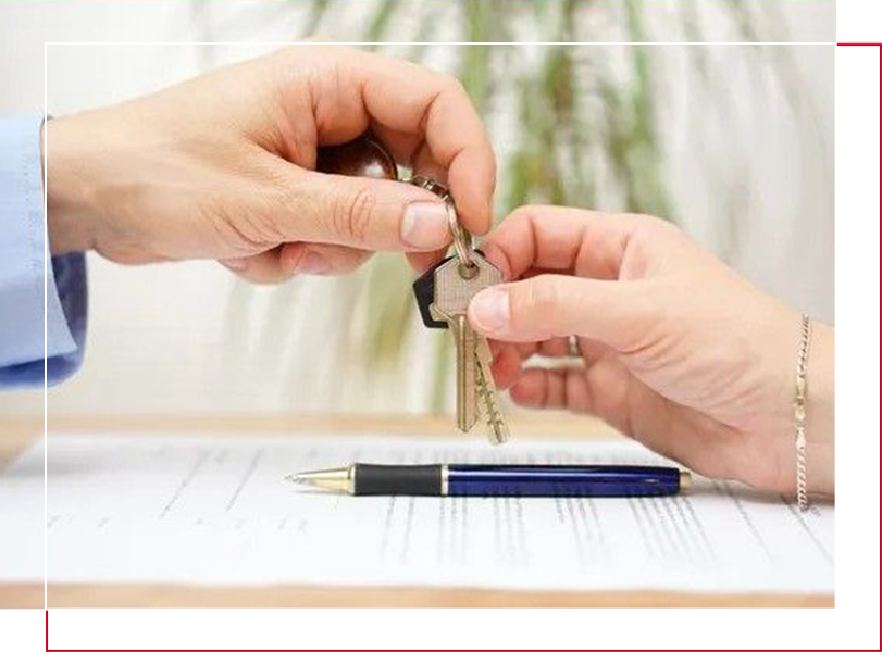 Two people holding keys to a house