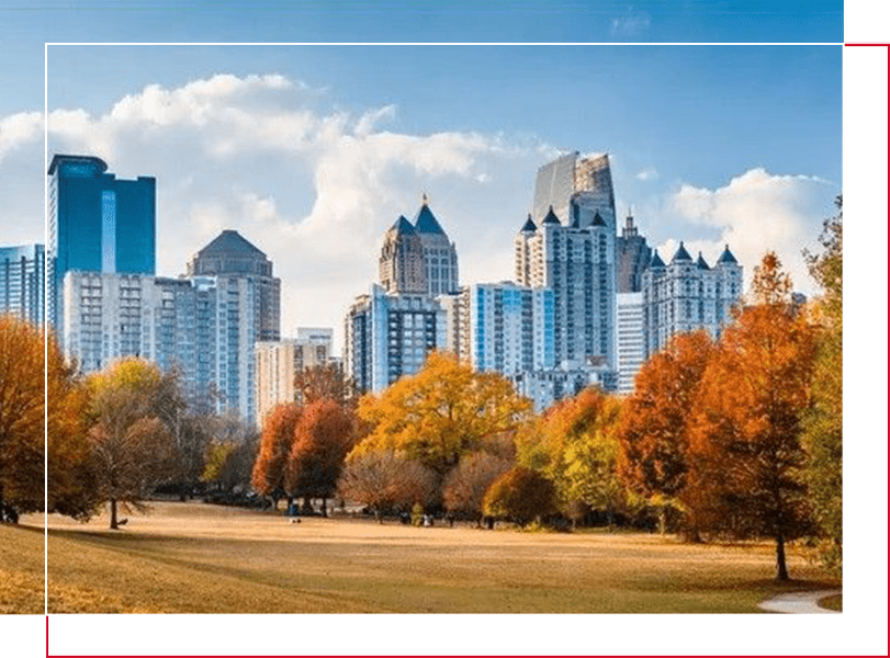 A city skyline with trees in the foreground.