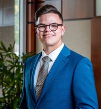 A man in a blue suit and tie.